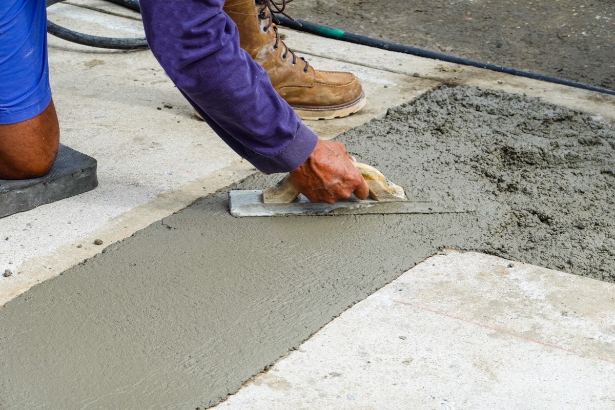 Concrete contractors near me hand-finishing a slab
