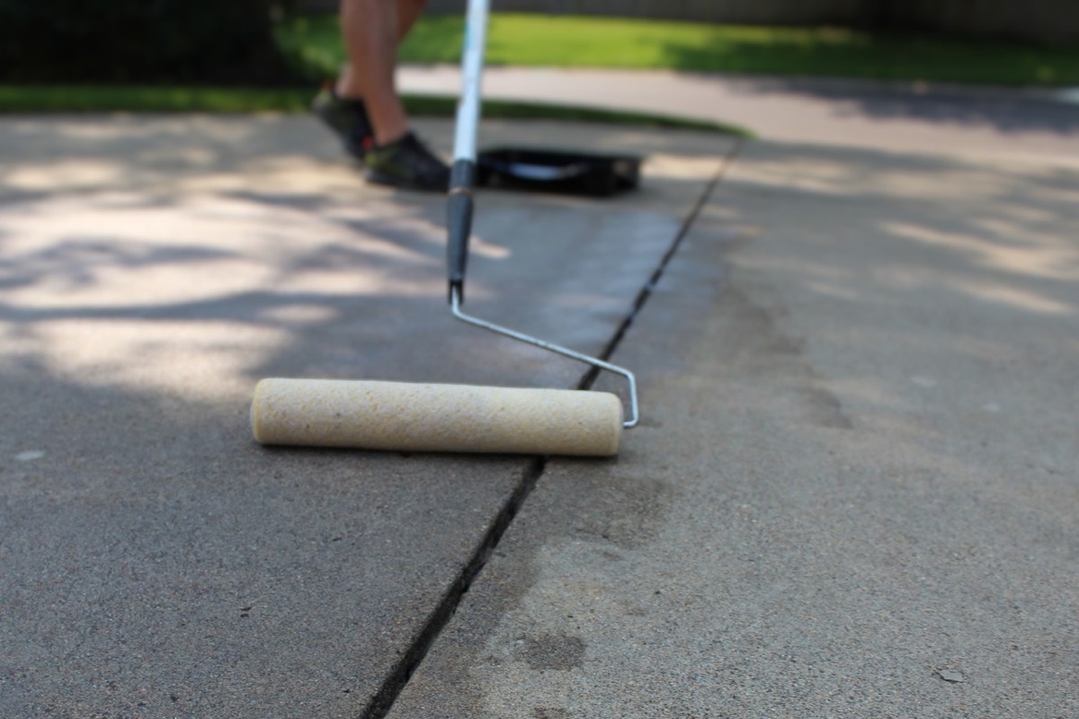 Concrete driveway contractors sealing a driveway